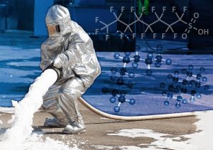 Firemen spray firefighting foam