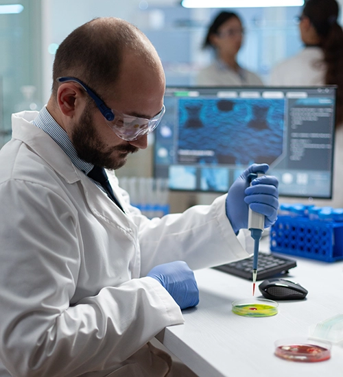 Scientist working in laboratory holding pipette.