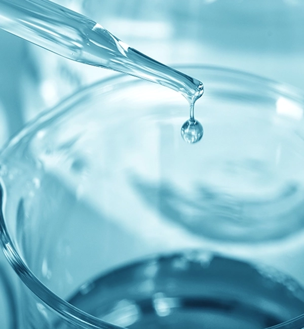 Pace Building Sciences Environmental Contaminants. Pipette dropping liquid into beaker.